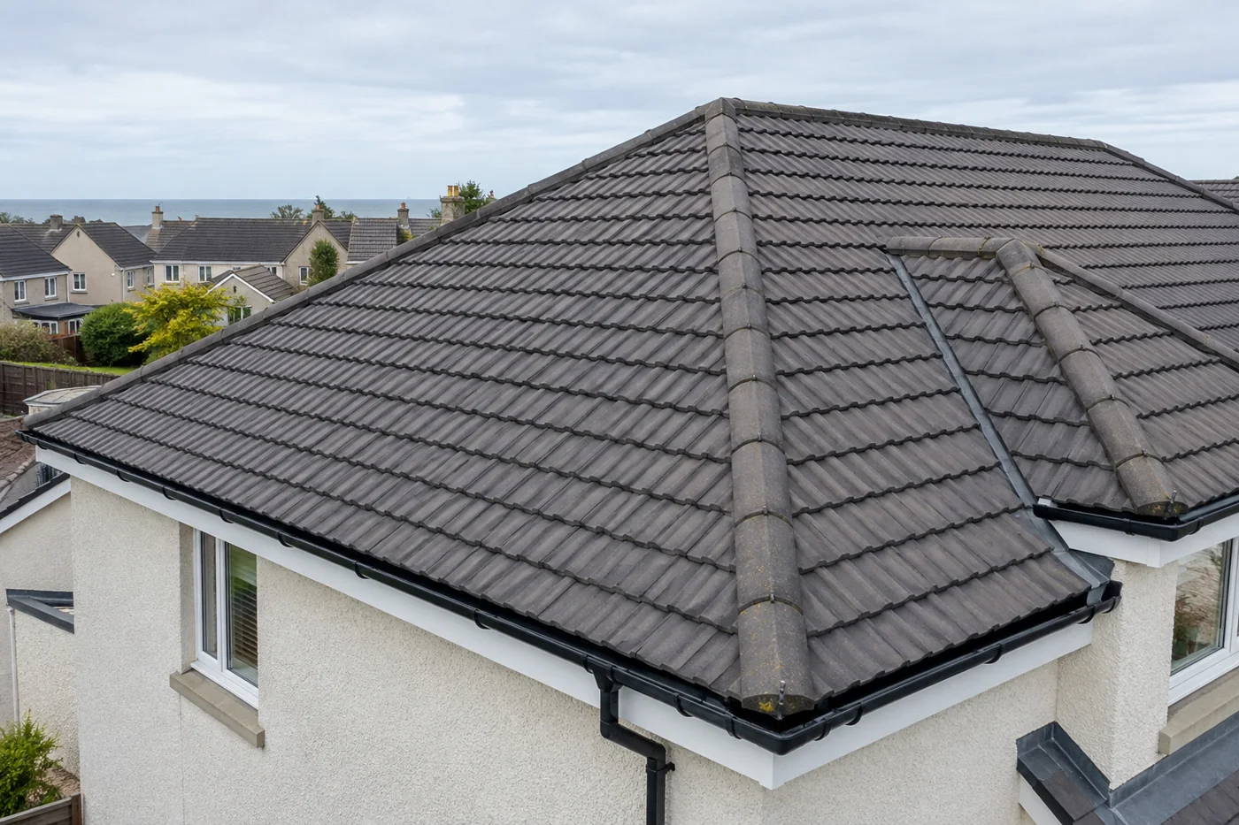 Interlocking tiled domestic roof and ridge